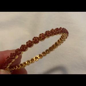New Ruby red & gold bangle with small floral design.Think it’s gold over…